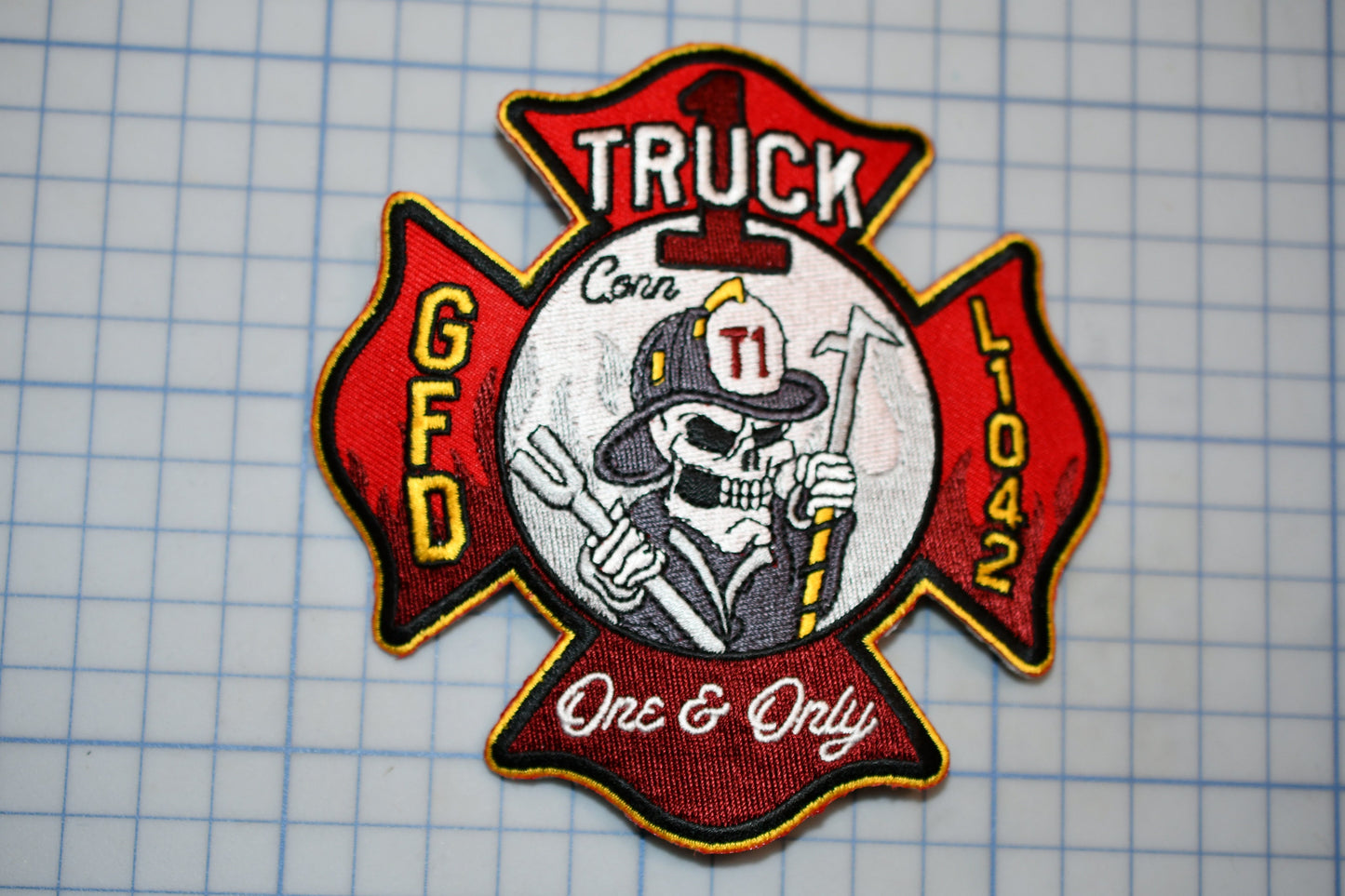 a patch with a firefighter's helmet and a skull, along with the text "Truck" and "FD" on it.