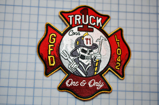 a patch with a firefighter's helmet and a skull, along with the text "Truck" and "FD" on it.