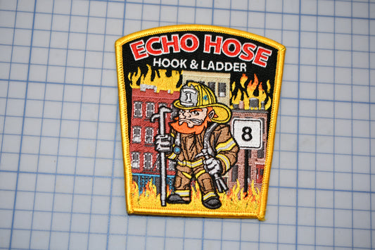 a patch with a fireman holding a fire hose
