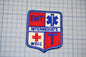 a patch with a red and blue design, displaying the words "EMT" and "INTERMEDIATE" along with a medical symbol.