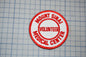 A red and white patch with the text "MOUNT SINAI VOLUNTEER MEDICAL CENTER" printed on it, placed on a grid background.