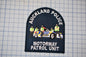 a police patch with a car and several police officers, representing the Auckland Motorway Patrol Unit.