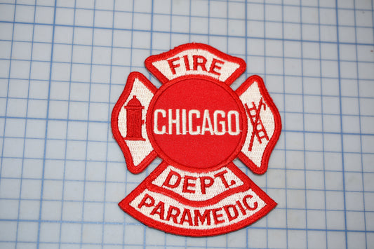 a red and white patch with the text "CHICAGO DEPT. PARAMEDIC" and a fire hydrant symbol, indicating it is a patch from the Chicago Fire Department's Paramedic department.