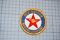a patch with the text "RICE INSTITUTE NURSING ASSISTANT" and a red star, all set against a blue and white grid background.