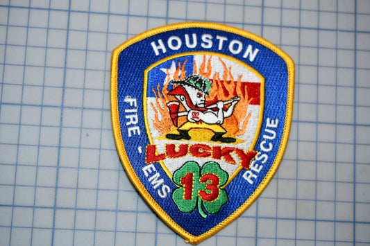 A patch with the text "HOSTON FIRE & EMERGENCY RESCUE" and an image of a firefighter, along with the number "13".