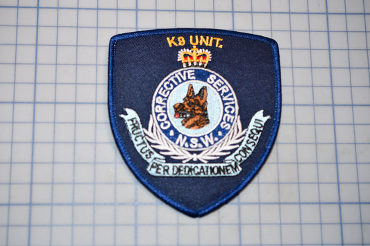 a blue police badge sitting on top of a piece of paper