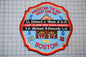 A patch with a fire department emblem, featuring a fire engine, a building, and text that reads "Protecting the Bay Night and Day".