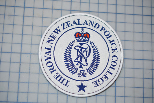 a circular badge with the text "THE ROYAL NEW ZEALAND POLICE COLLEGE" printed on it.
