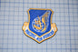a blue and gold patch with the text "PACIFIC AIR FORCES" on it, which appears to be a military or service insignia.