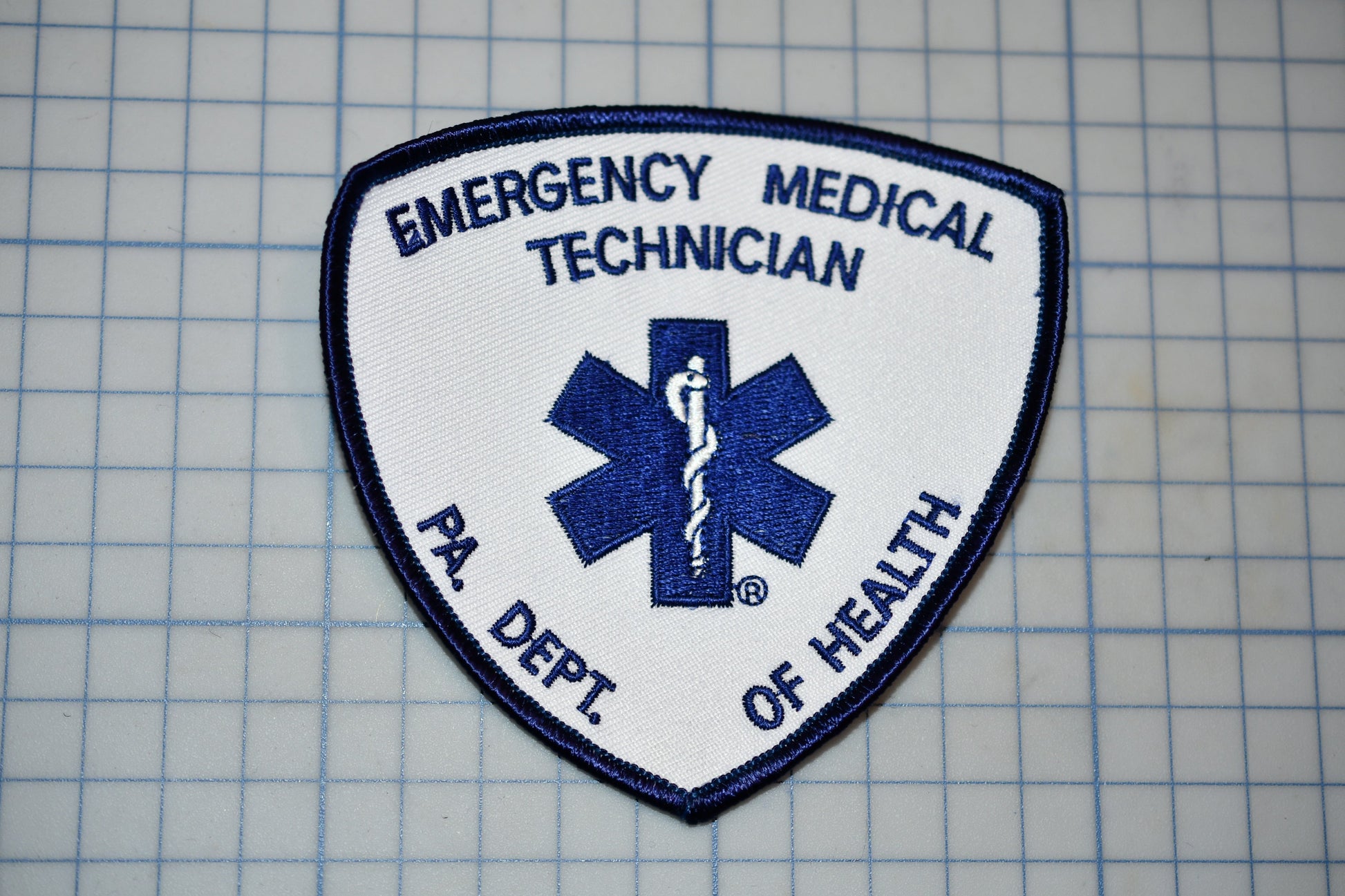 a medical emergency technician patch with a blue and white design.