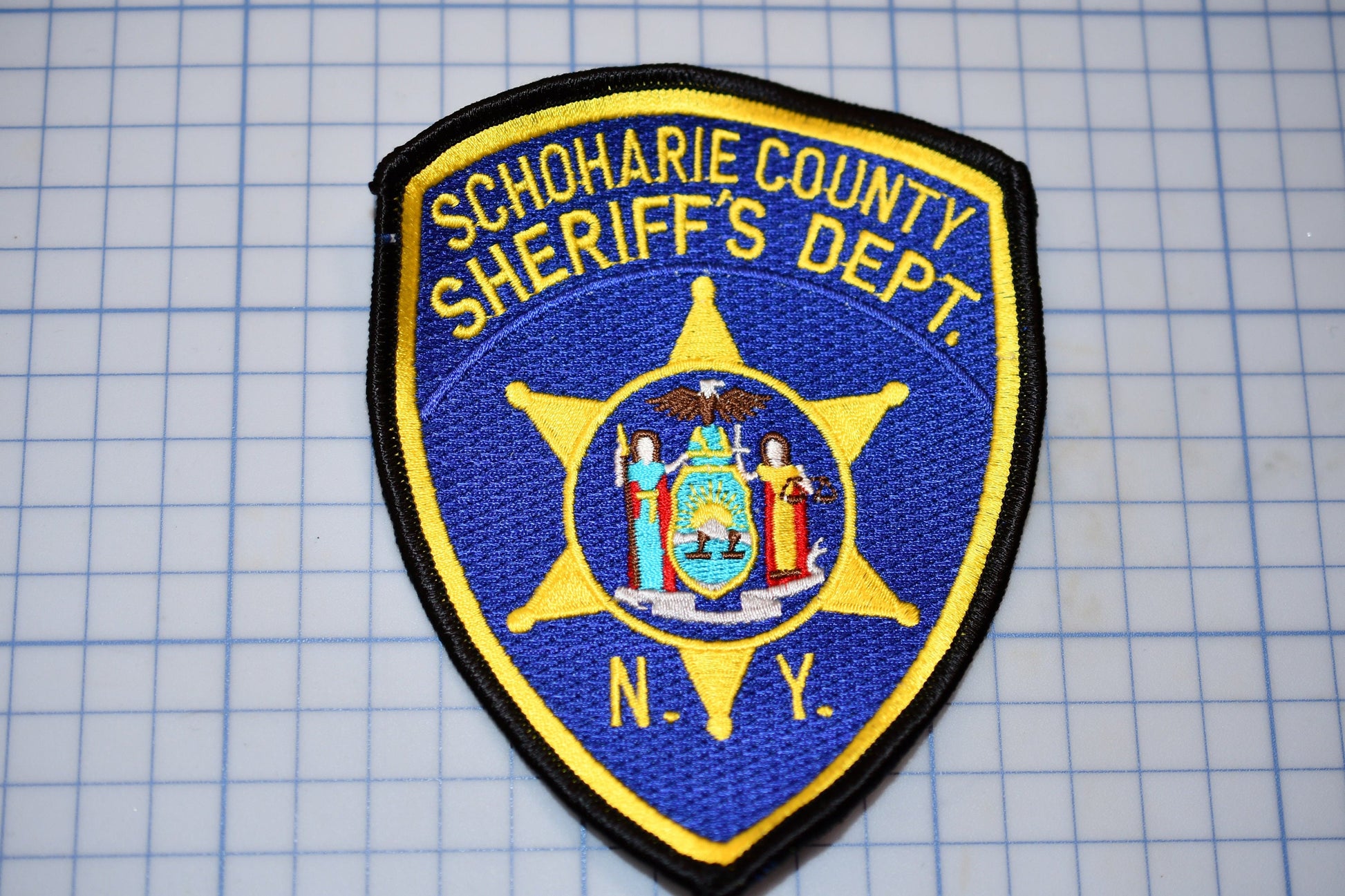 a blue and yellow patch with the words schroaie county sheriff&#39;s