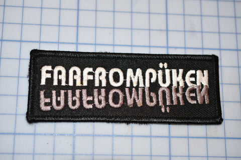 a black and white patch with the words fangorompunken written in white