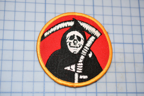 a patch with a skeleton holding a sculler