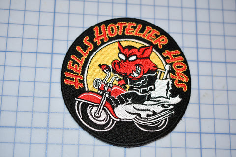 a patch with a picture of a devil riding a motorcycle
