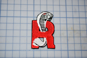 a red and white patch with a skeleton on it