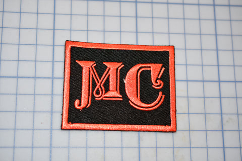 a black and orange patch with the letter jc on it