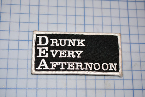 a patch that says drunk every afternoon on it