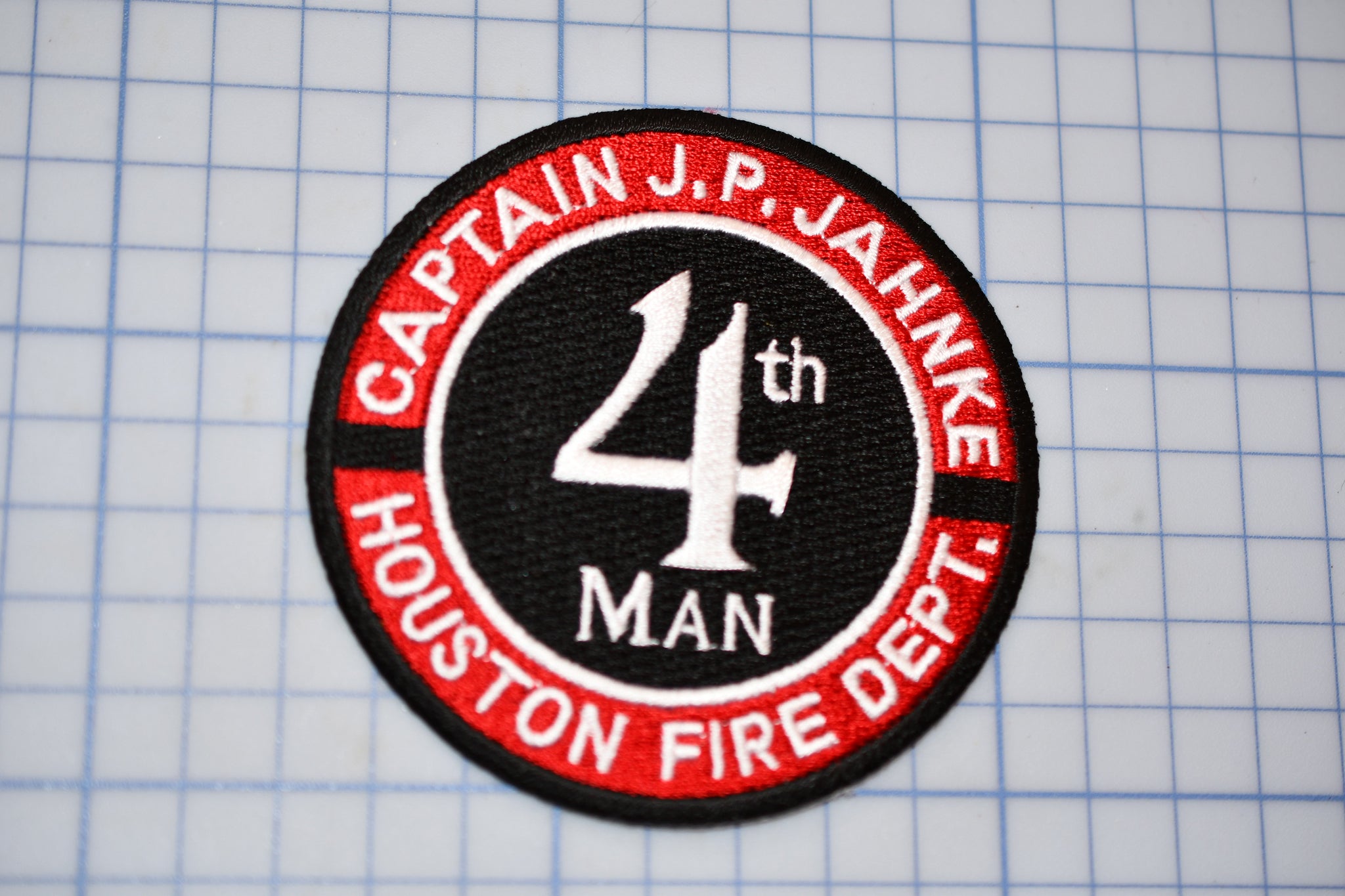 a red and black patch with the number four on it
