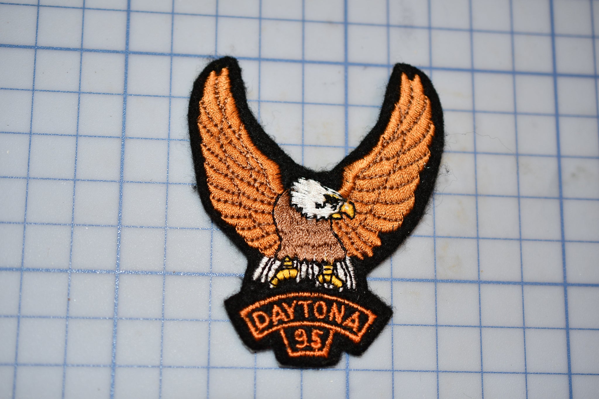 a close up of a patch with an eagle on it