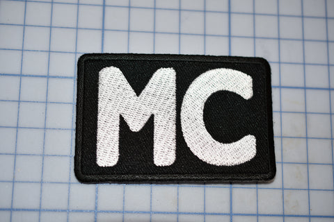 a black and white patch with the letter m on it